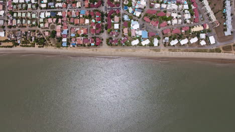 Vertical-drone-shot-of-the-ocean-and-front-beach-neighbourhood-Guiana